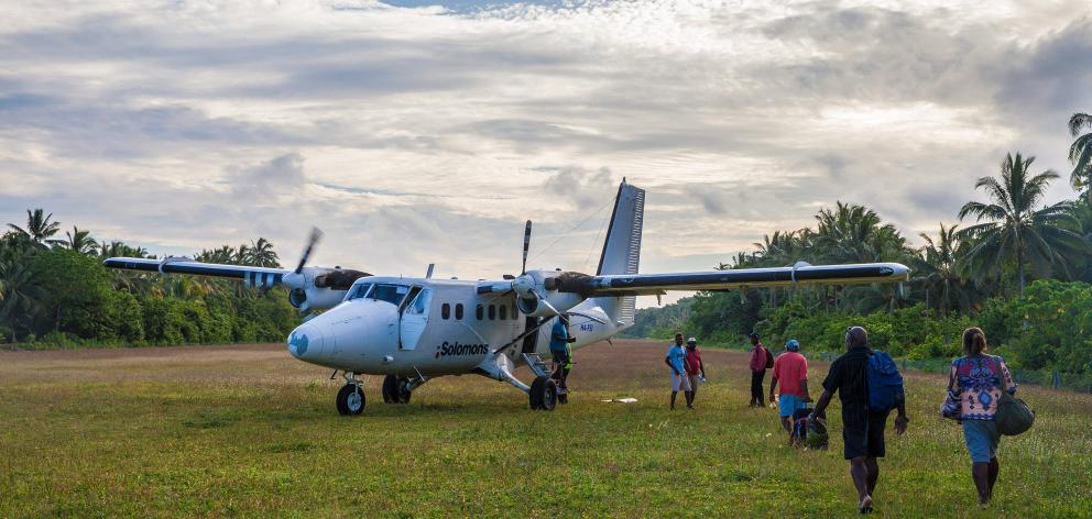 Sixteen-passenger Twin Otters, work horse of Solomon Island Air interisland flights, keeps the...