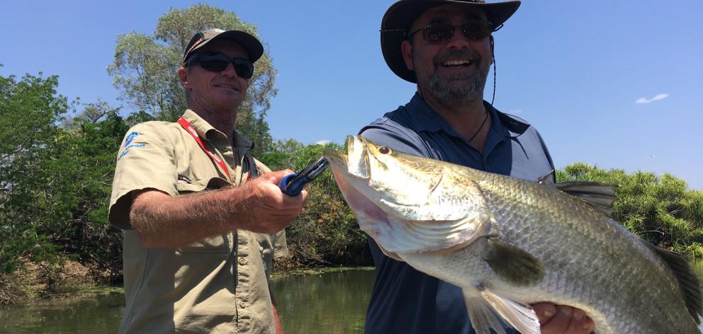 Yellow Water Fishing Charters guide Greg Patterson (left) and Alexandra fisherman Nuno Vilela with his first barramundi. Photo: Pam Jones Yellow Water Fishing Charters guide Greg Patterson (left) and Alexandra fisherman Nuno Vilela with his first barramundi. Photo: Pam Jones