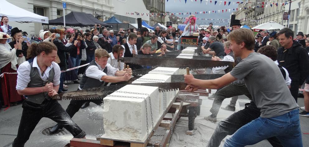 Competitors take part in the men’s doubles Oamaru stone-sawing championship. Photo: Daniel Birchfield