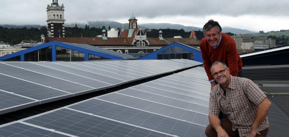 Southern Clams managing director Roger Belton (standing) and operations manager David Redshaw inspect new solar panels installed on the roof of the business in central Dunedin on Monday. Photo: Shawn McAvinue