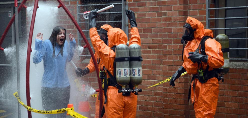 An actor experiences a decontamination shower during an emergency exercise at the Dunedin Medical School yesterday. Photo: Craig Baxter
