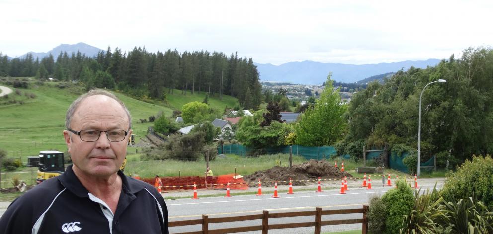 Mt Aspiring Rd resident Barry Bruce is unhappy about the construction of an 11m cellphone tower...
