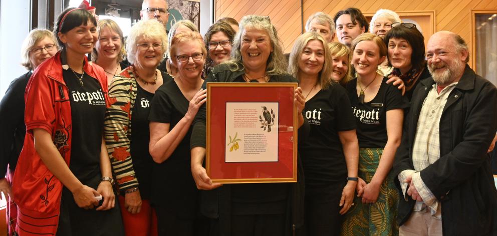 Dunedin Public Libraries citation winner Moana Wesley (holding the citation) with the waiata group she has led since 2002. Photo: Linda Robertson