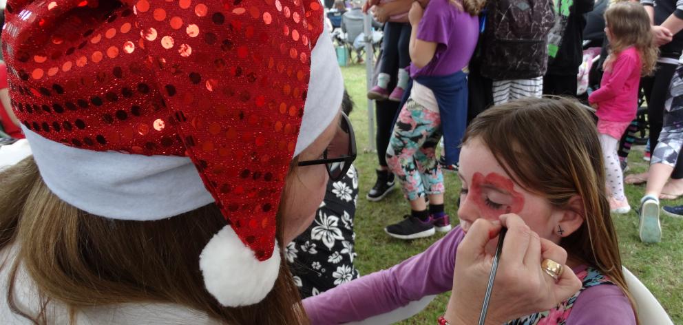 Miley Goodman (9, above) gets her face painted by Sylviane Gallant-Welch.