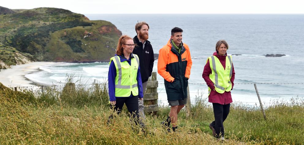 Phoebe Morrison (left), Dunedin City Council parks and recreation planner Stephen Hogg (second from left), Department of Conservation ranger Richard Seed and Lorena Smith start ranger training at Sandfly Bay yesterday. Photo: Peter McIntosh