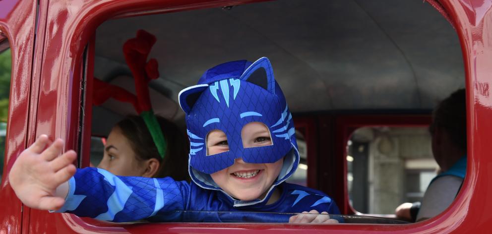 Waving to the crowd from inside a vintage fire appliance is Jamieson Loader (5). Photo: Gregor...