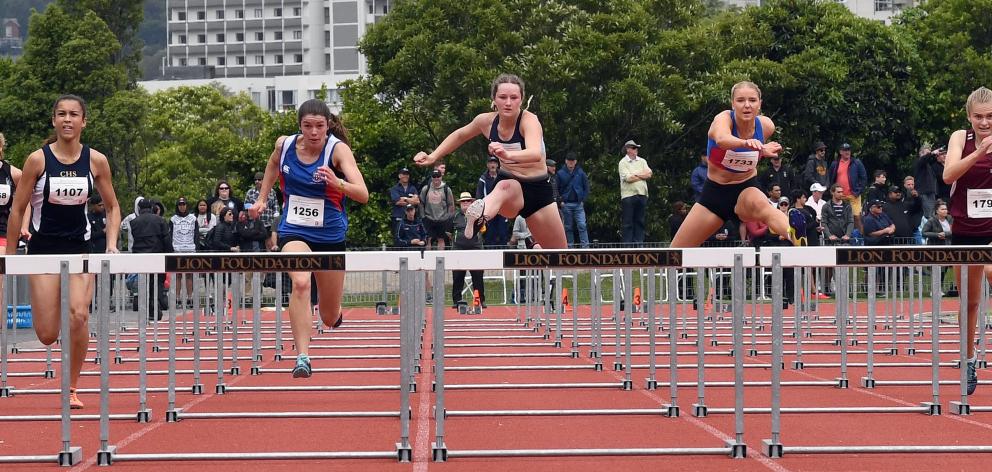 Taieri College's Tara McNally (third from right) competes during the final of the senior girls 100m hurdles at the national secondary school track and field championships at the Caledonian Ground on Sunday. Photos: Stephen Jaquiery