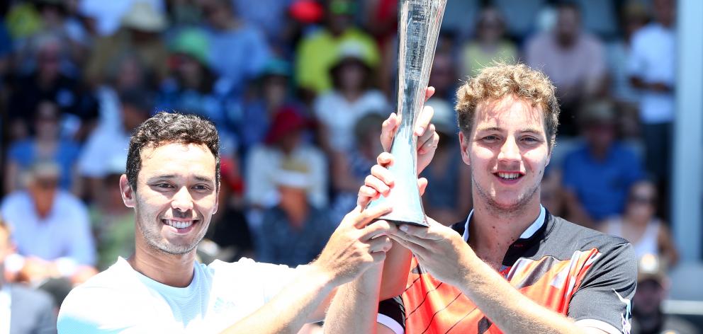 Ben McLachlan (left), of Japan,  and Jan-Lennard Struff, of Germany,  celebrate with the trophy...