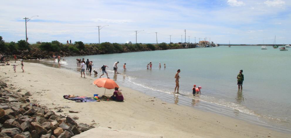 As temperatures approached 30degC in Oamaru about noon yesterday, Friendly Bay Beach at Oamaru Harbour was an oasis for several families. Photo: Hamish MacLean