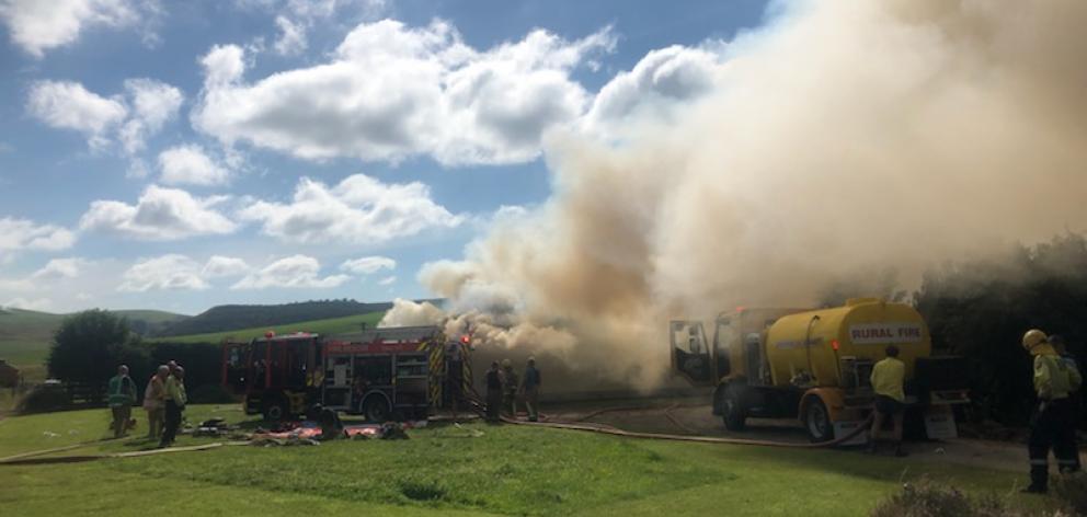 Smoke rises from a house on fire near Oamaru this morning. Photo: Rebecca Ryan