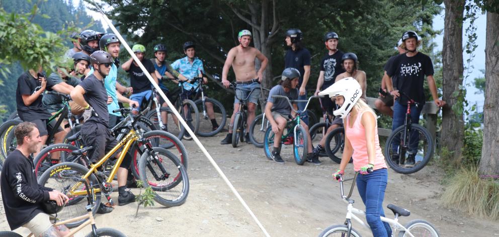 Riders from the Queenstown biking community wait to drop in at the Gorge Road Jump Park yesterday...