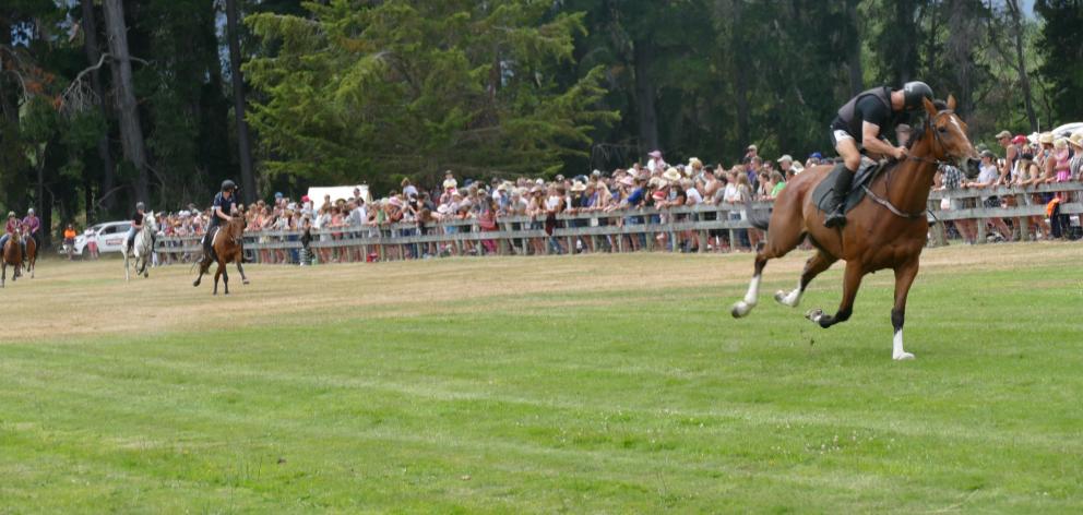 Glenorchy rider Calder Houliston (right) and his horse Harry on the home straight in the...
