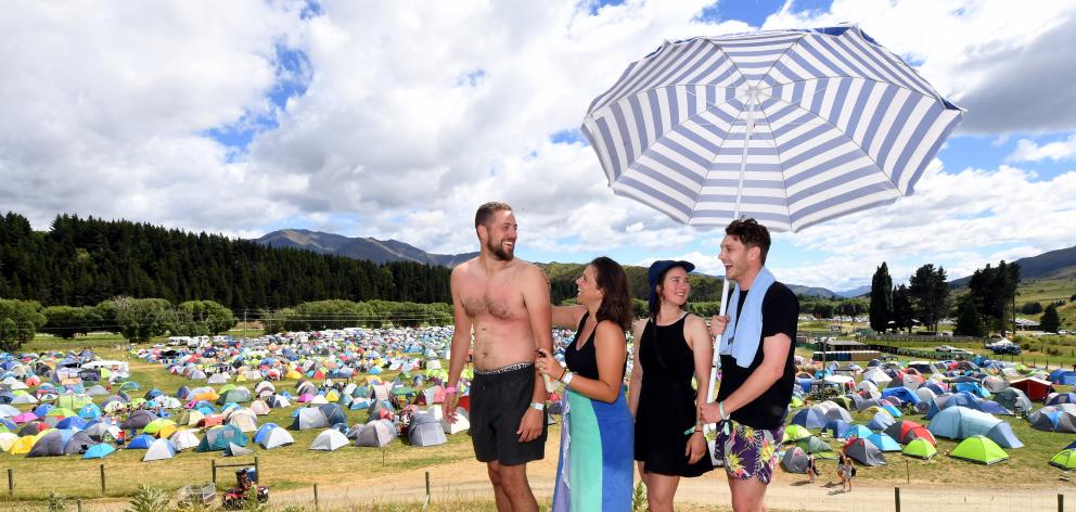 Visitors from Melbourne (from left) Jonathan Edgley, Caroline Szylkrot, Claudia Mitchell and Jay Shackleton apply sunscreen as temperatures rise towards Australian levels. 