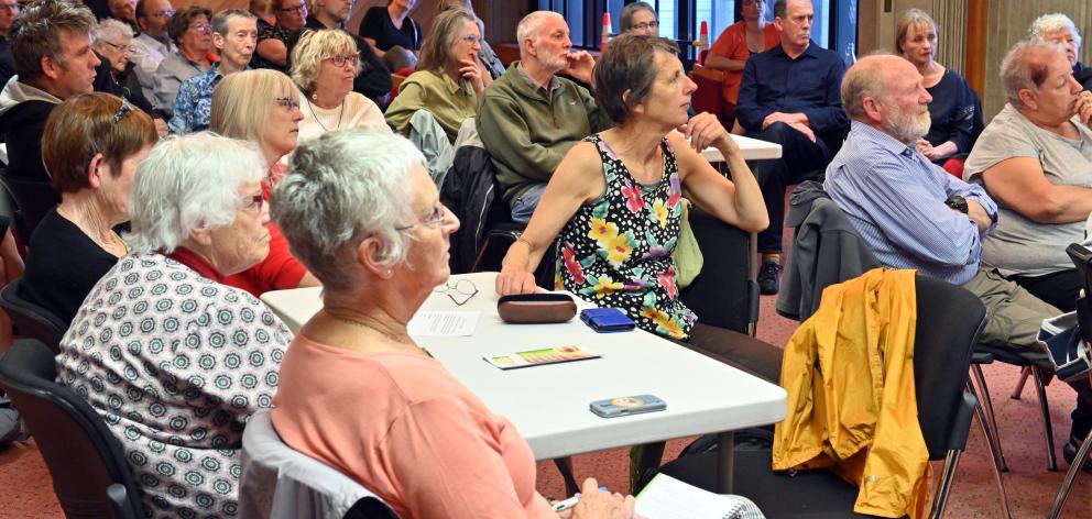 Audience members listen to answers to their questions. 