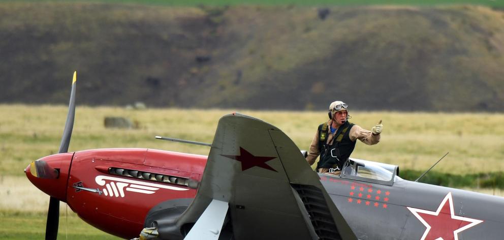 Yak-3 pilot Arthur Dovey signals he is unhurt after the aircraft he was landing collided with a cherry picker on the grass runway at Warbirds over Wanaka in March last year. Photo: Stephen Jaquiery
