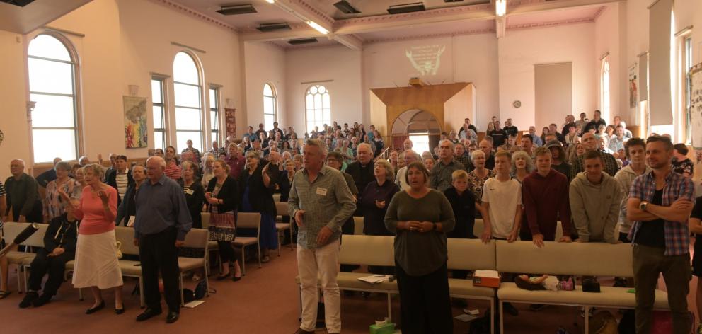 A packed church sings during Roly and Trudy Scott’s farewell service. Photos: Linda Robertson