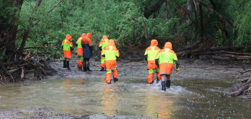 Members of the Fiordland Search and Rescue team  look near the Manuherikia River for Mr Bates in...