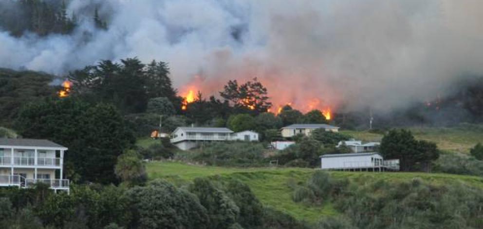 A suspicious fire at Ahipara last Friday forced the evacuation of homes and destroyed a bach and a shed. Photo: NZ Herald