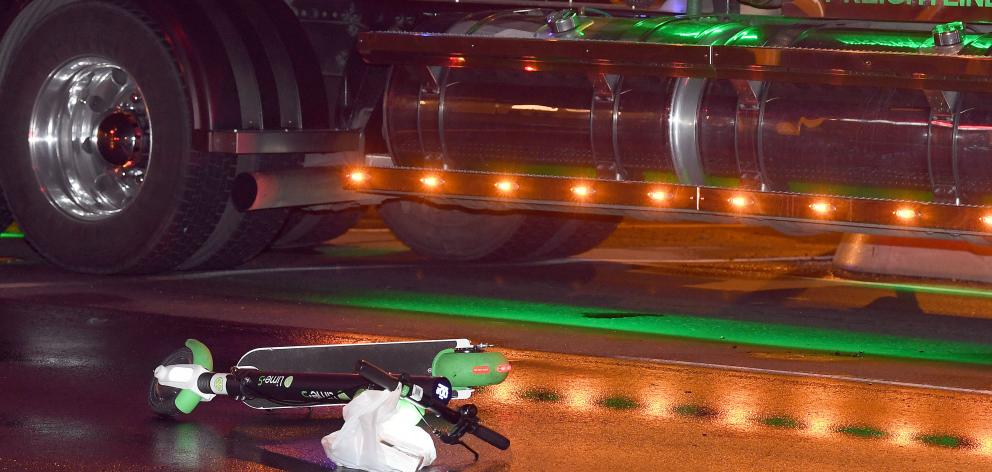 A Lime e-scooter lies on the road beside a truck after a crash in the early hours of this morning. Photo: Stephen Jaquiery