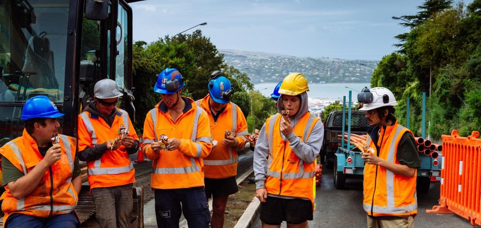 Work crews preparing trenches for the new underground cable powering Dunedin’s city centre celebrate reaching the top of Stuart St with an ice cream on a hot day last week. Photo: Supplied Work crews preparing trenches for the new underground cable powering Dunedin’s city centre celebrate reaching the top of Stuart St with an ice cream on a hot day last week. Photo: Supplied