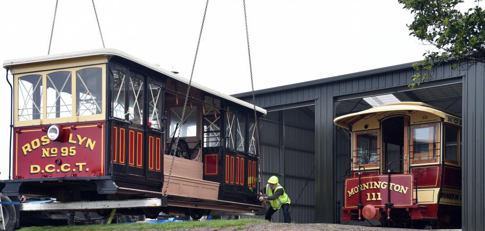 Dunedin Heritage Light Rail Trust spokesman Neville Jemmett as restored cable car Roslyn No 95 is lifted into place at the trust's Mornington shed.Photo: Peter McIntosh