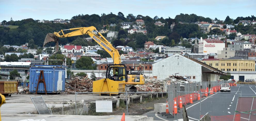 Demolished sections of the Fryatt St sheds are scooped into containers yesterday. PHOTO: PETER...
