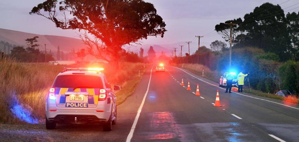 Police work at the scene of a fatal car accident near Palmerston yesterday. Photo: Stephen Jaquiery