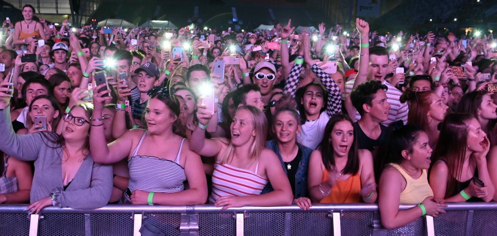 Concert-goers photograph themselves at the Six60 concert.
