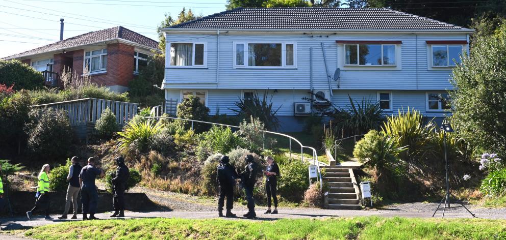 Police armed offenders personnel search the property in Somerville St, Dunedin, on Saturday....