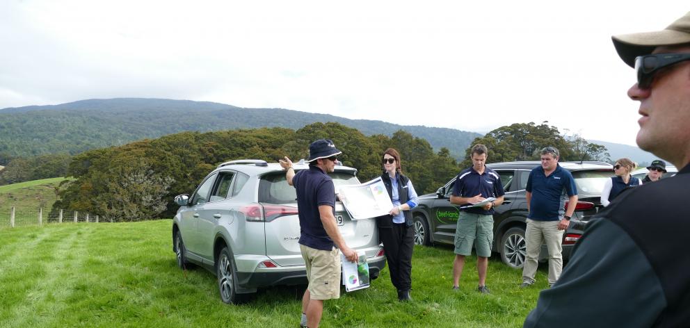 Pourakino farmer Geordie Eade (centre) discusses the paddock maps with farmers at last week's field day. Claire Bekhuis, from Ballance Agri-nutrients, is helping with the map. Photo: Ken Muir