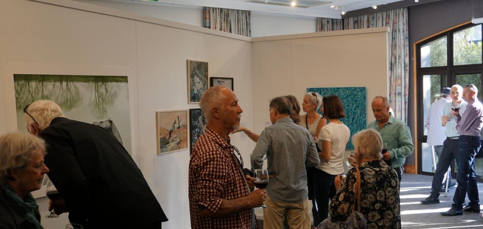 Members of the Wanaka community get their first glance at the Wai Water Wanaka exhibition. PHOTO:...