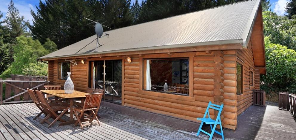 An American couple are selling their alpine-style log house on Corsican Drive. Photo: Supplied
