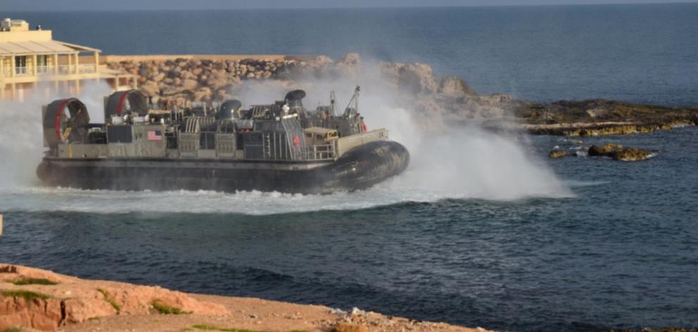 A United States amphibious hovercraft departs with evacuees from Janzur, west of Tripoli, Libya....