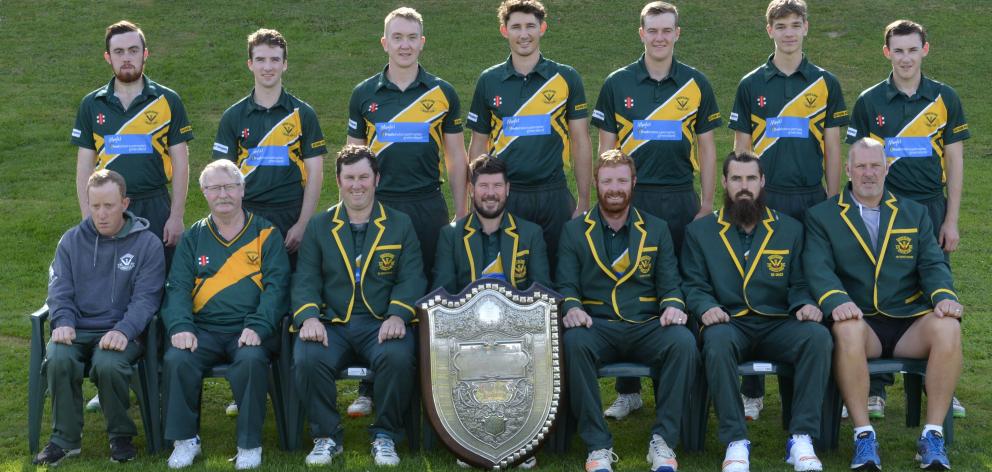 Lobb (front row, centre) props up the Bing Harris Shield after Green Island won it again this...