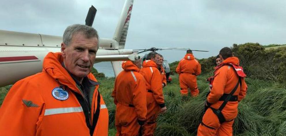 Southern Lakes Helicopters pilot and CEO Sir Richard Hayes on Enderby Island with others involved in the Auckland Islands rescue. Photo: Southern Lakes Helicopters