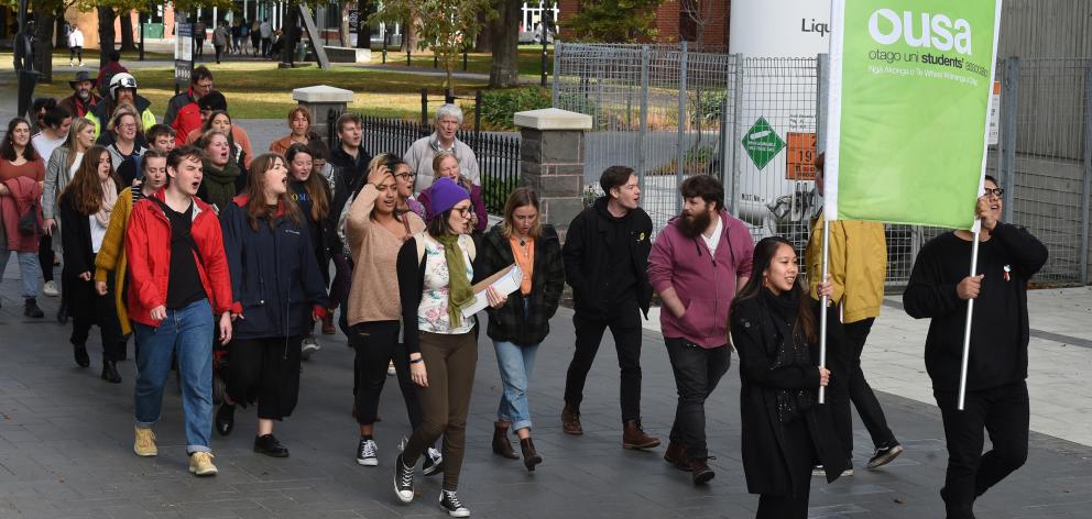 Postgraduate students and other members of the university community march at a rally demanding...