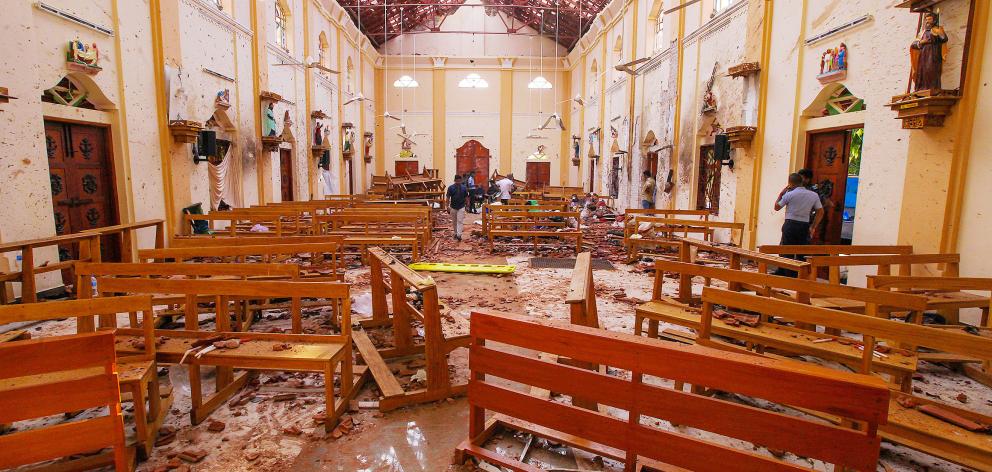(NO ARCHIVE)Crime scene officials inspect the site of a bomb blast inside St Sebastian's Church in Negombo. Photo: Reuters 