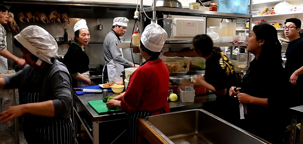 As on most nights, the Asian restaurant's kitchen is a hive of activity before diners arrive for...