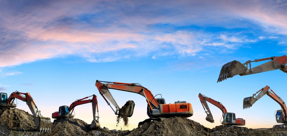Multiple backhoe diggers on a construction site. Photo: Getty Images 