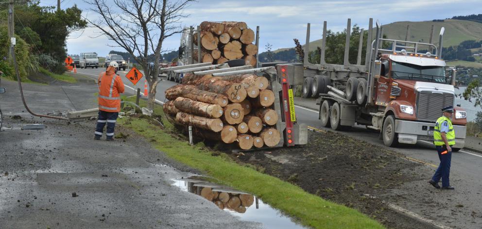 Dunedin police make inquiries at the scene of an accident involving a logging truck at Maia yesterday morning. Photo: Gerard O'Brien