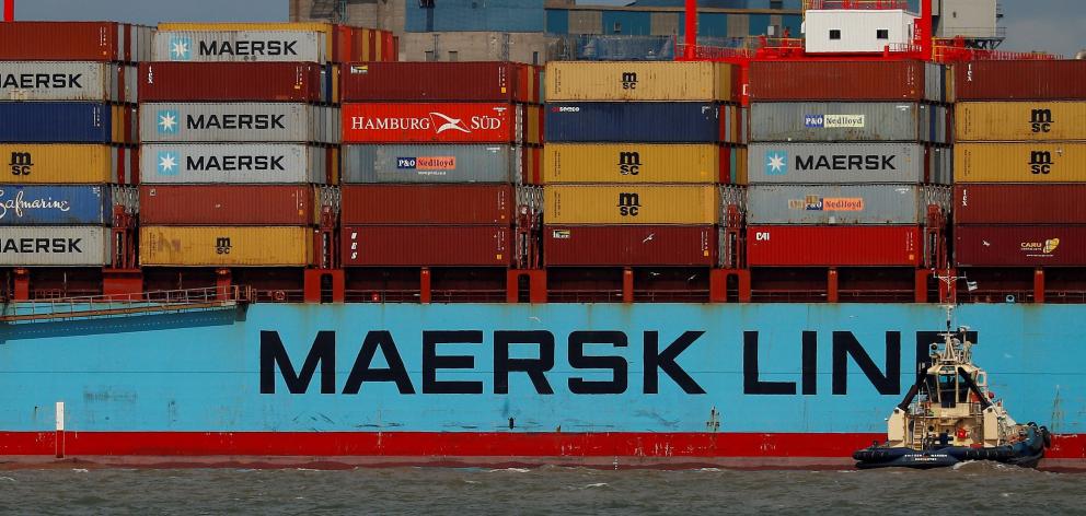 the Maersk Line's container ship Maersk Sentosa is assisted by a tug as it navigates the River...