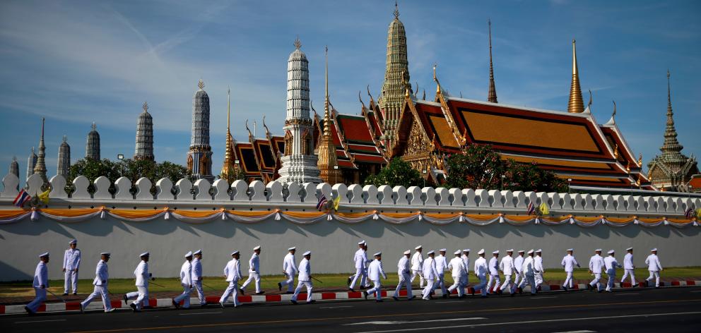 Officials walk past the Grand Palace during the coronation of King Maha Vajiralongkorn in Bangkok, Thailand. Photo: Reuters Officials walk past the Grand Palace during the coronation of King Maha Vajiralongkorn in Bangkok, Thailand. Photo: Reuters