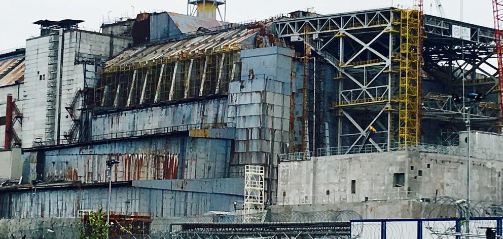 The crumbling sarcophagus that covered the remains of the ill-fated reactor No4, seen here not...