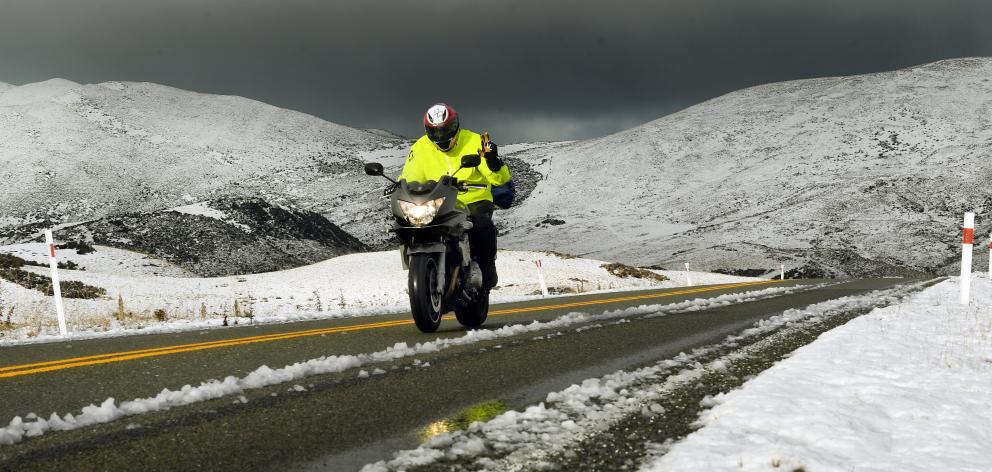 A motorcyclist gives a warm wave in chilly conditions on the Pigroot as he makes his way to the...