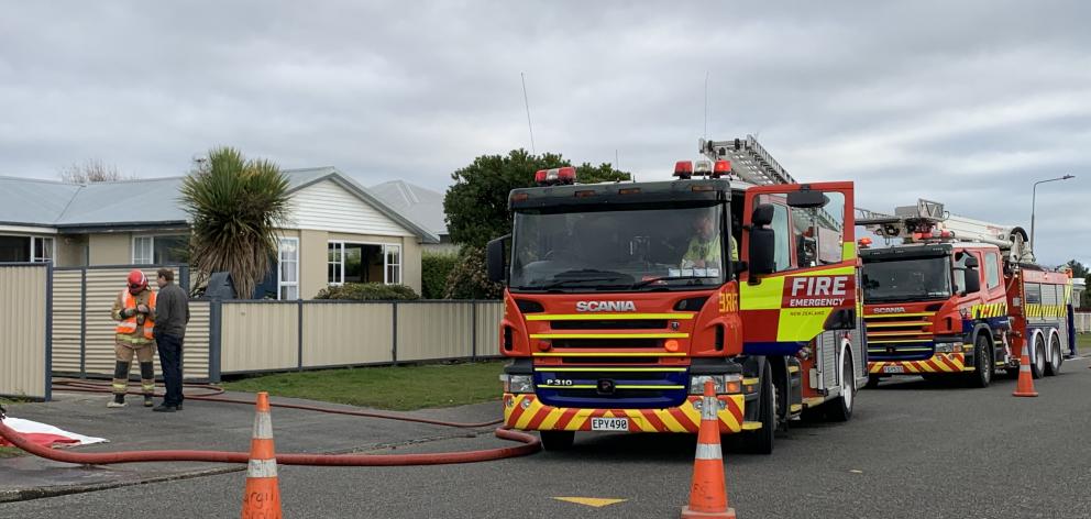 Firefighters at the scene of the house fire in Dome St, Invercargill. Photo: Abbey Palmer