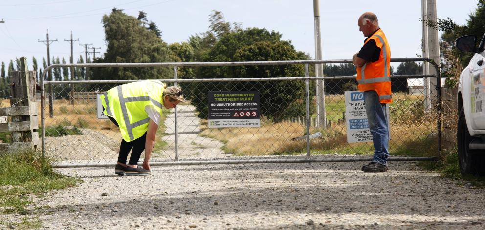In January, a WorkSafe New Zealand official examines the Gore sewage treatment site gate through...