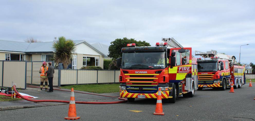 Firefighters arrive at a "well involved'' fire in the garage of a property in the Invercargill suburb of Newfield yesterday. Photo: Abbey Palmer