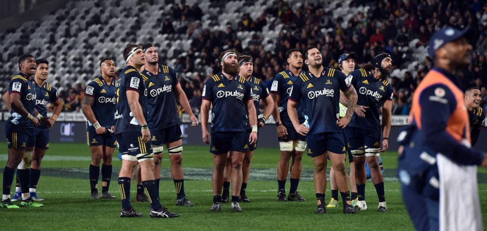 Highlanders players look up at a big screen  to see if   they have scored  against  the Bulls in...