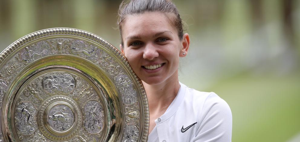 Simona Halep poses with the trophy after her Wimbledon victory. Photo: Reuters