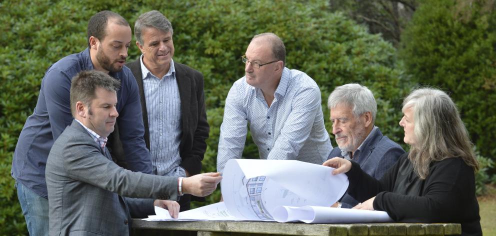 Looking at plans of the Ashburn Clinic expansion are (from left) project manager David Booth and...
